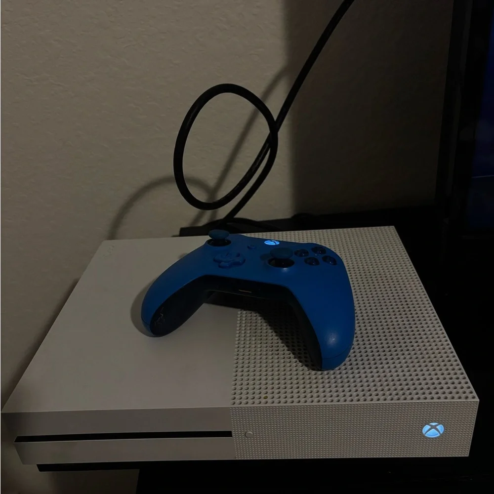 Sleek White Console with Vibrant Blue Controller